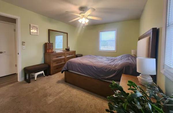 a bedroom with a bed and a chandelier