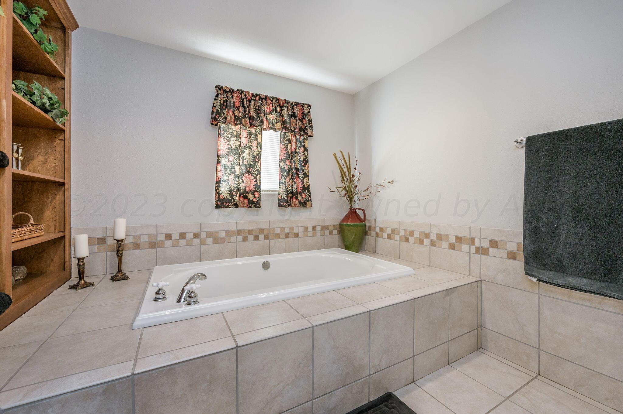 7424 Olton Road Plainview, TX 79072 - Photo 24 of 55 a bathroom with a bathtub and a sink