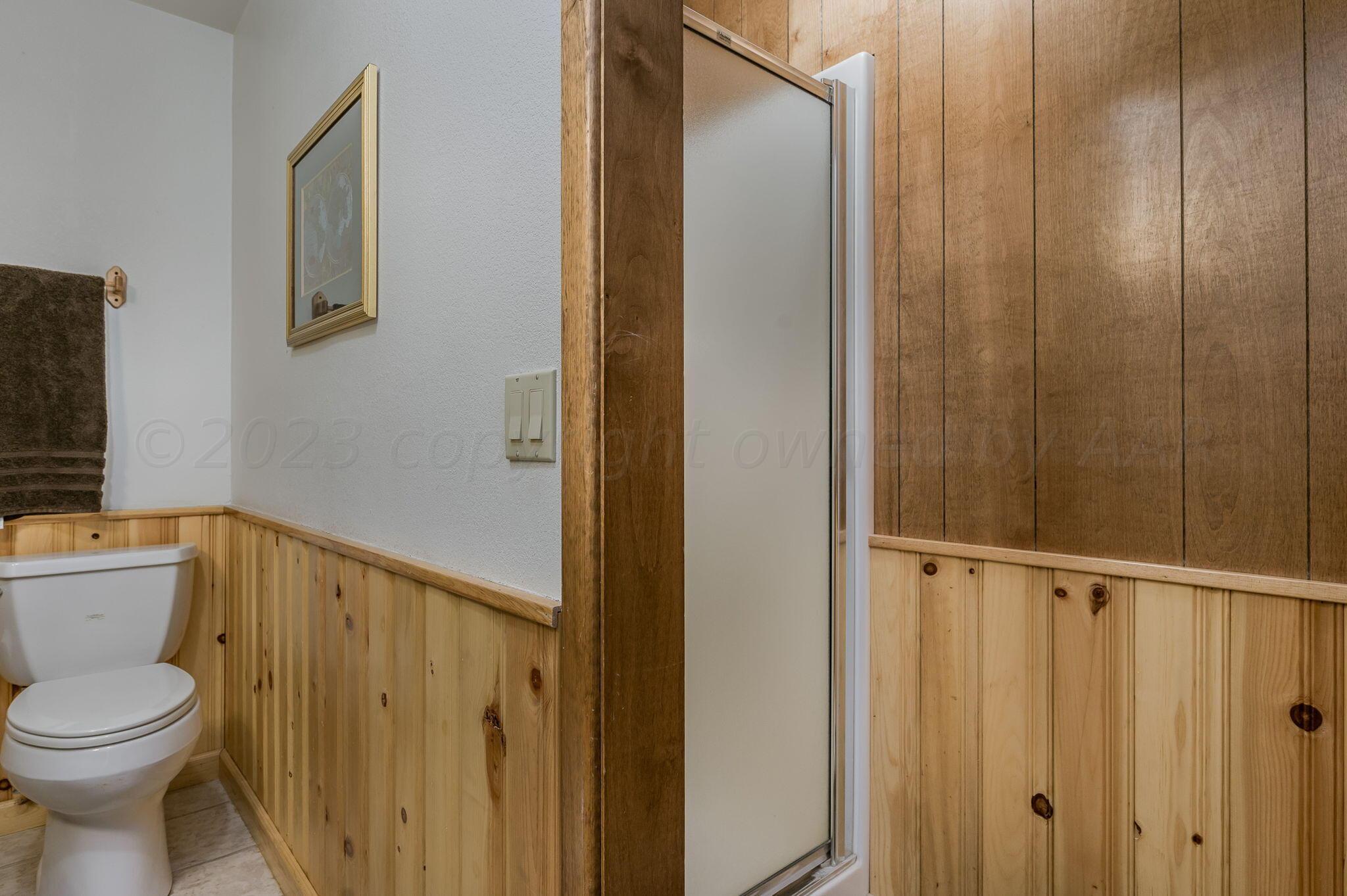 7424 Olton Road Plainview, TX 79072 - Photo 32 of 55 a bathroom with a toilet a sink and shower