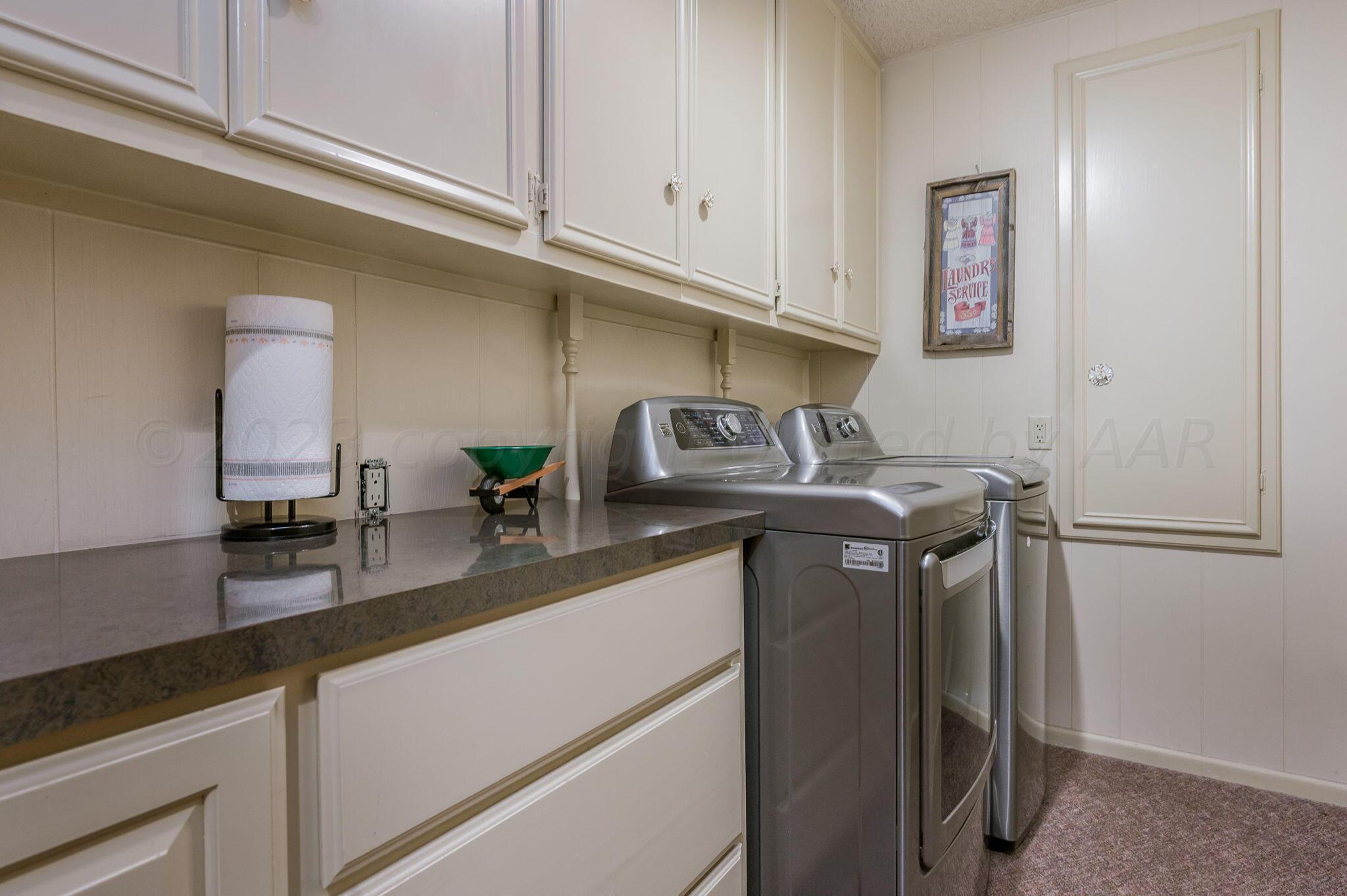 7424 Olton Road Plainview, TX 79072 - Photo 33 of 55 a kitchen with stainless steel appliances granite countertop a sink a refrigerator and a granite counter tops