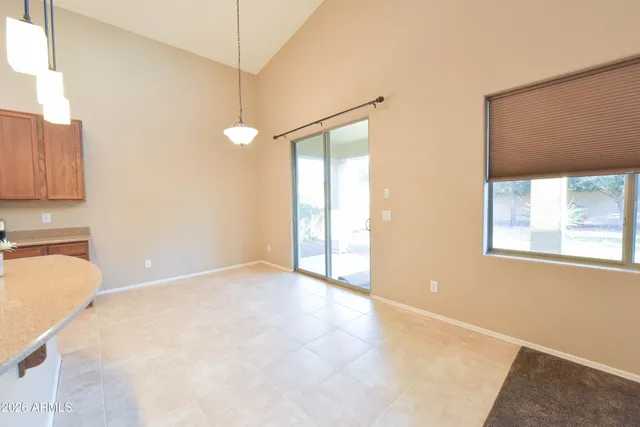 a view of a kitchen with a fridge and window