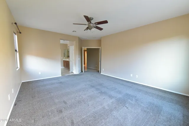 a view of a livingroom with a ceiling fan and window