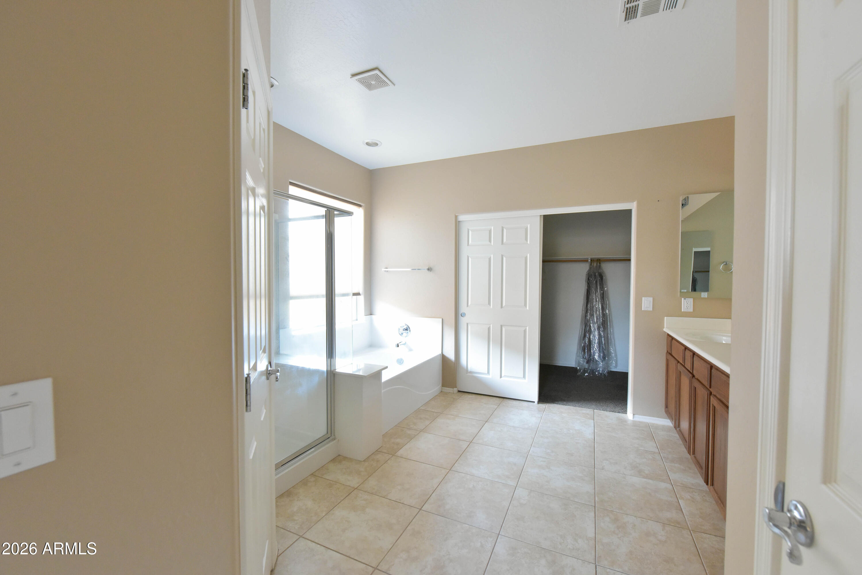 2546 East San Rafael Trail Casa Grande, AZ 85194 - Photo 19 of 41 a view of an empty room and bathroom with a tub and shower
