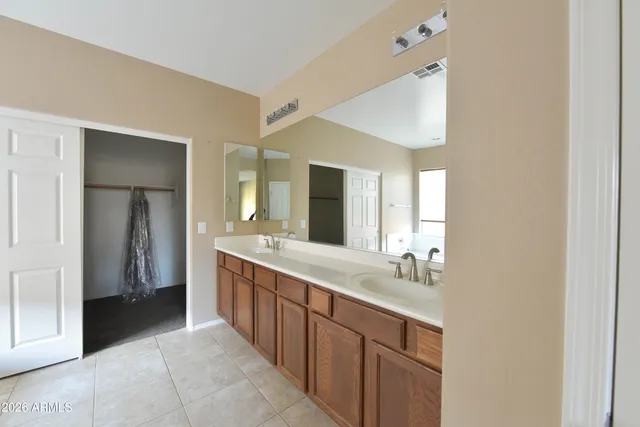 a spacious bathroom with a double vanity sink and a mirror