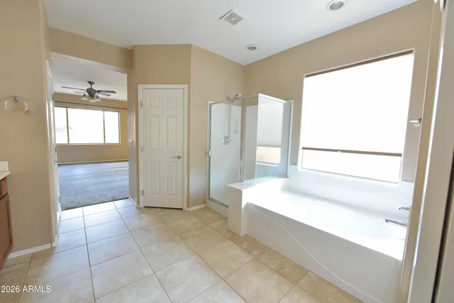 a spacious bathroom with a tub shower and sink