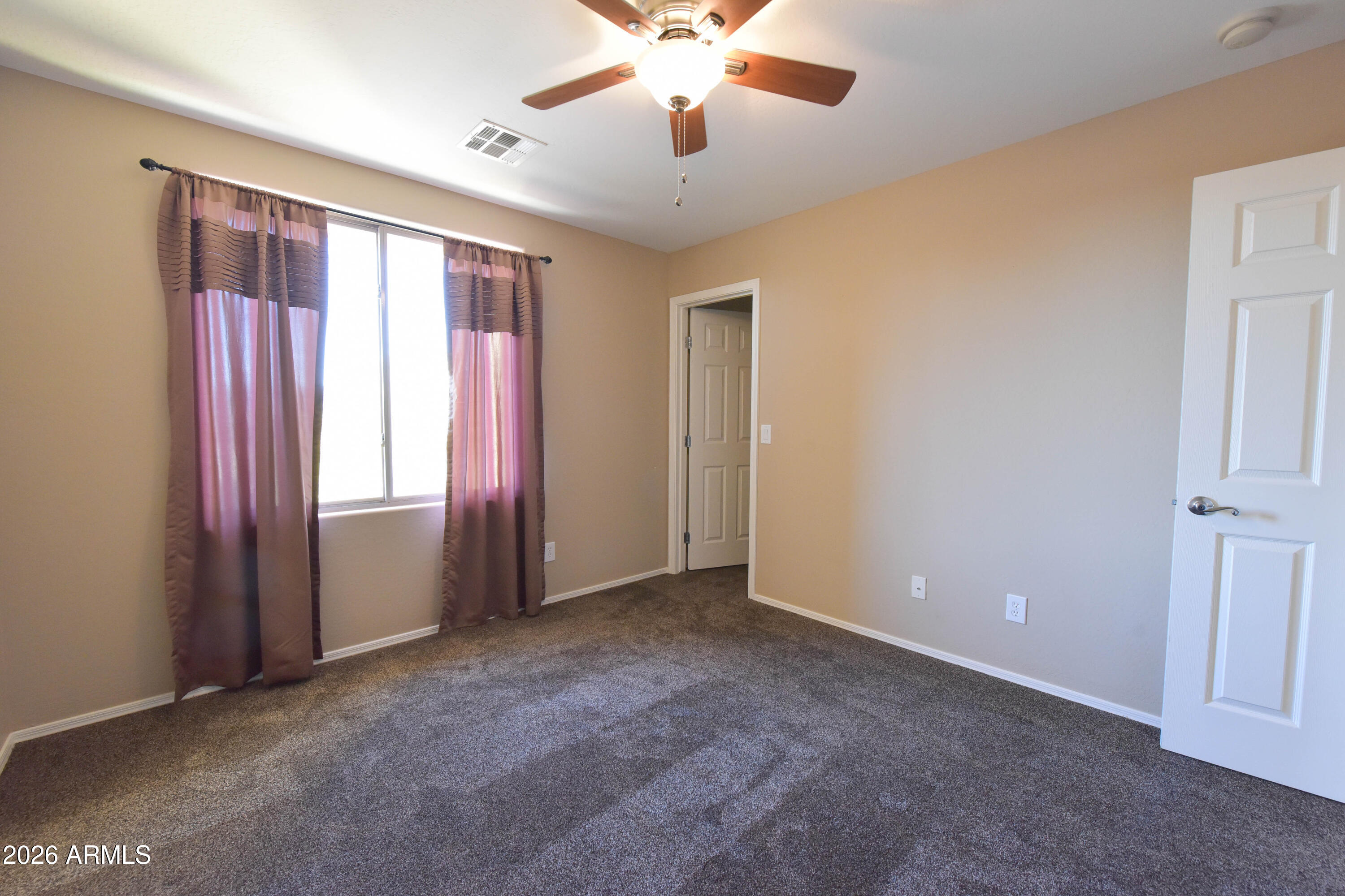 2546 East San Rafael Trail Casa Grande, AZ 85194 - Photo 34 of 41 a view of an empty room with window and a kitchen