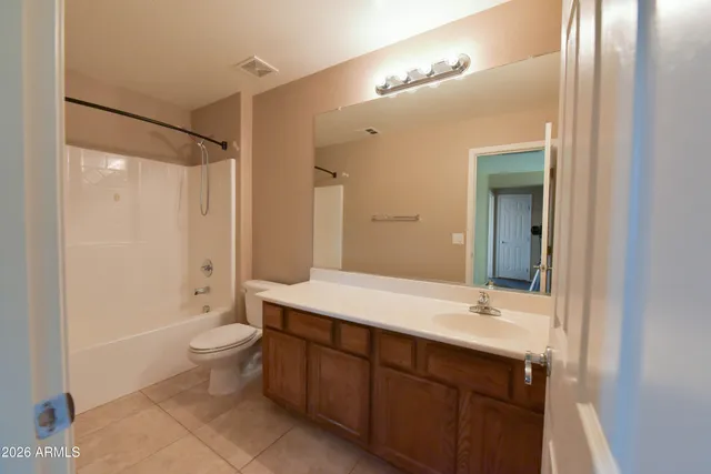 a bathroom with a double vanity sink toilet mirror and bathtub