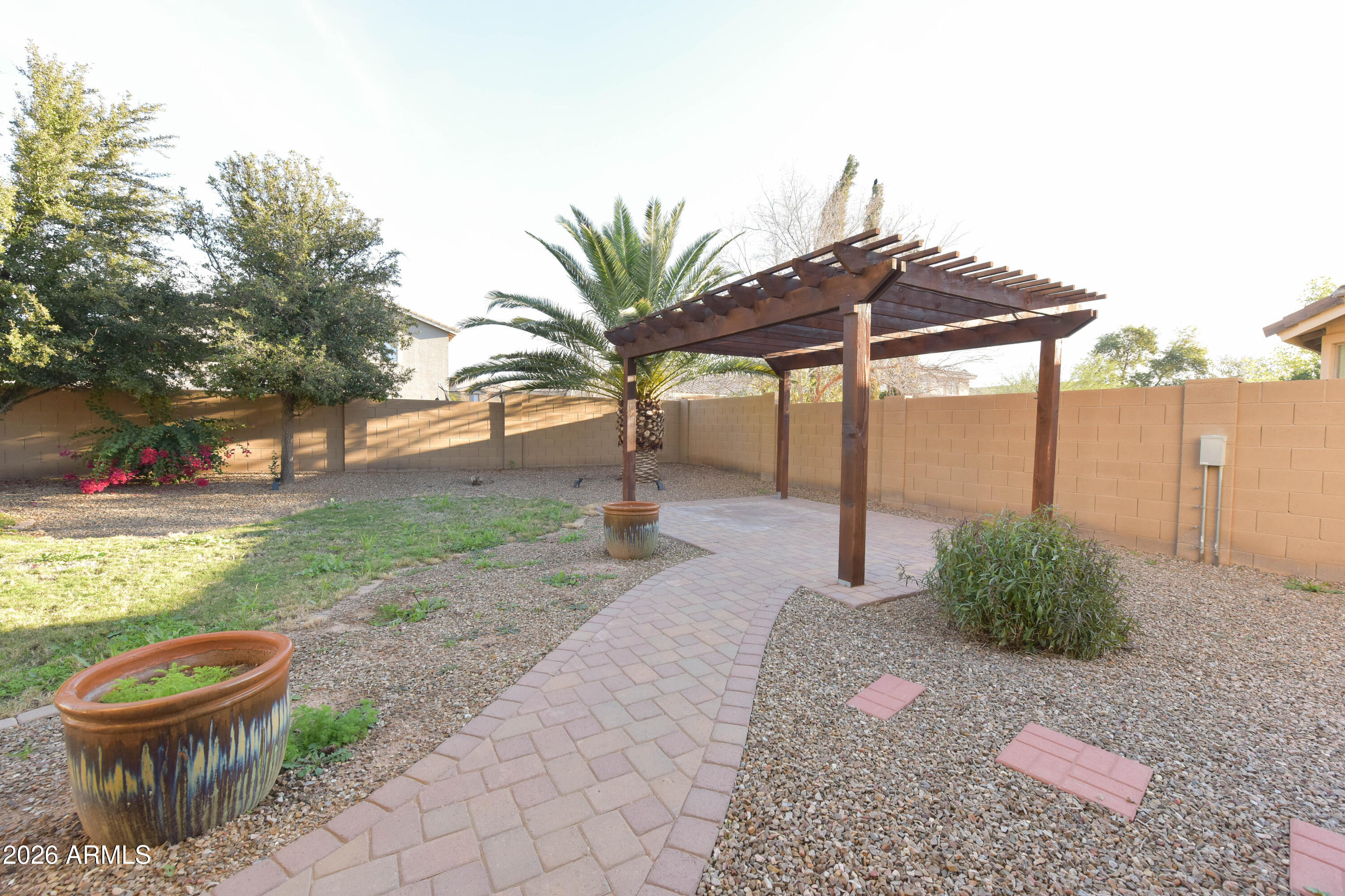 2546 East San Rafael Trail Casa Grande, AZ 85194 - Photo 38 of 41 a view of a backyard with plants and a lawn chairs