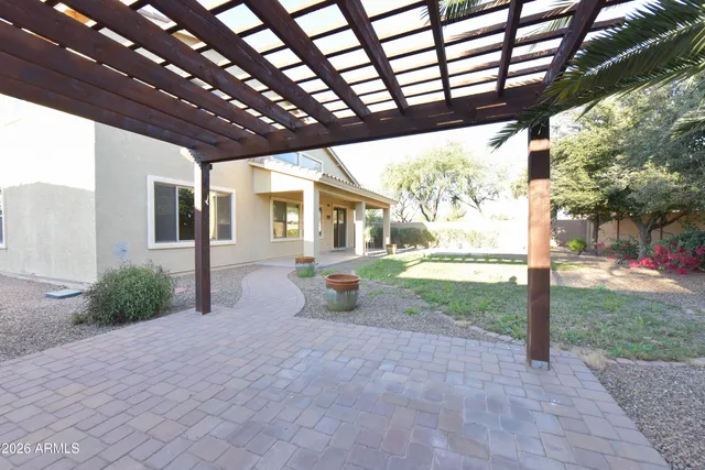a view of a house with backyard and sitting area