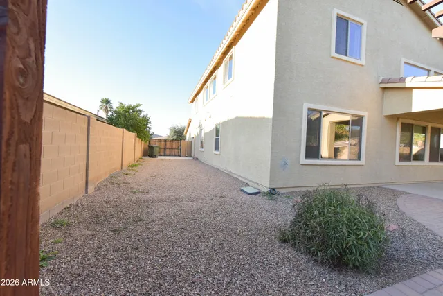 a view of a house with backyard and trees