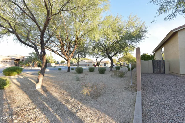 a view of a house with trees from a backyard