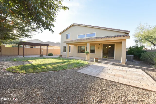 a view of a house with a backyard