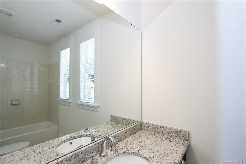 908 Millbrook Road, Unit B Charlotte, NC 28211 - Photo 15 of 23 a bedroom with a bed and a window
