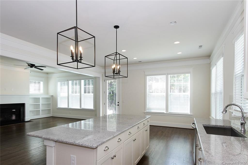 908 Millbrook Road, Unit B Charlotte, NC 28211 - Photo 3 of 23 a kitchen with stainless steel appliances granite countertop a sink a stove and a wooden floors
