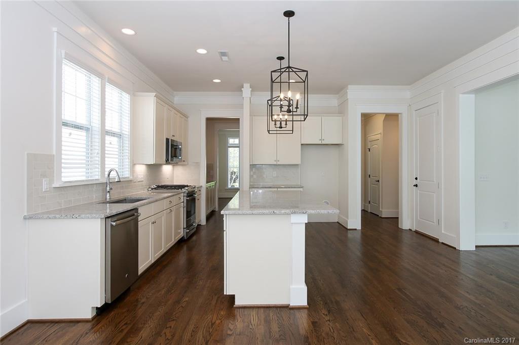 908 Millbrook Road, Unit B Charlotte, NC 28211 - Photo 4 of 23 a large kitchen with stainless steel appliances granite countertop a sink a stove and a wooden floors