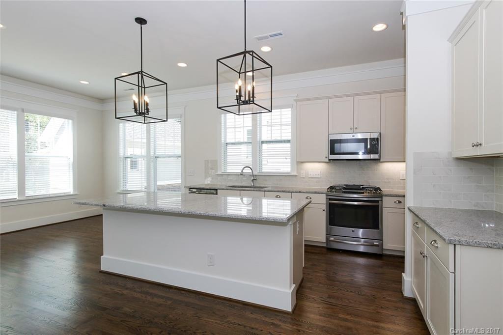 908 Millbrook Road, Unit B Charlotte, NC 28211 - Photo 6 of 23 a kitchen with stainless steel appliances granite countertop a stove a sink and a wooden floor