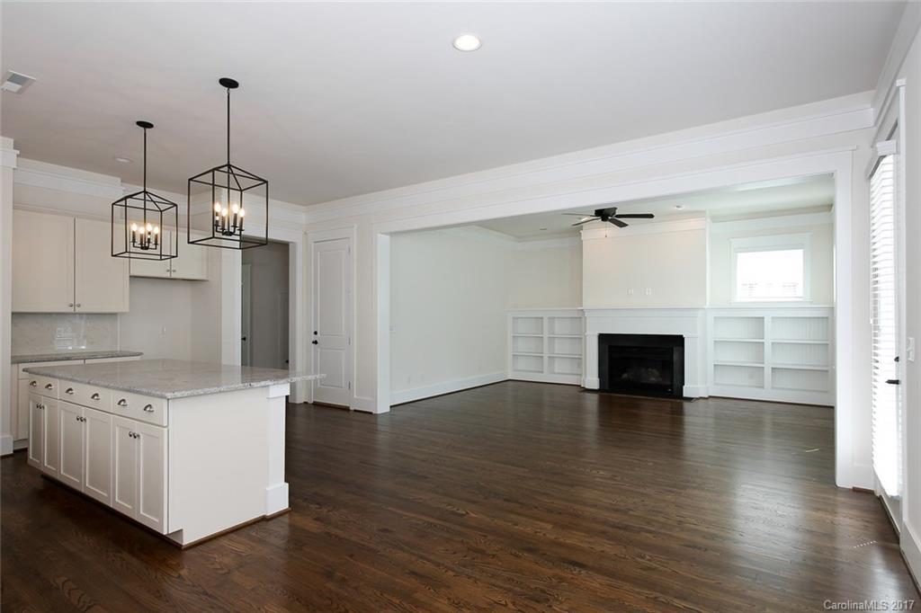 908 Millbrook Road, Unit B Charlotte, NC 28211 - Photo 7 of 23 an empty room with wooden floor and fireplace