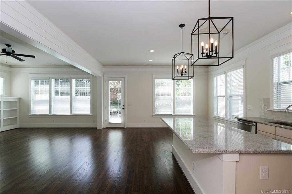 908 Millbrook Road, Unit B Charlotte, NC 28211 - Photo 8 of 23 a view of empty room with wooden floor and fan