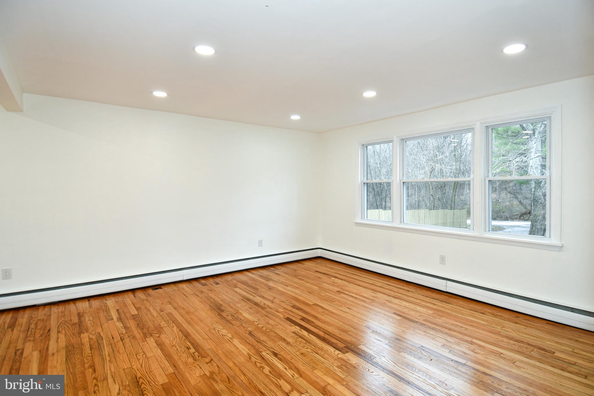 26904 Overlook Street Damascus, MD 20872 - Photo 11 of 54 a view of an empty room with wooden floor and a window