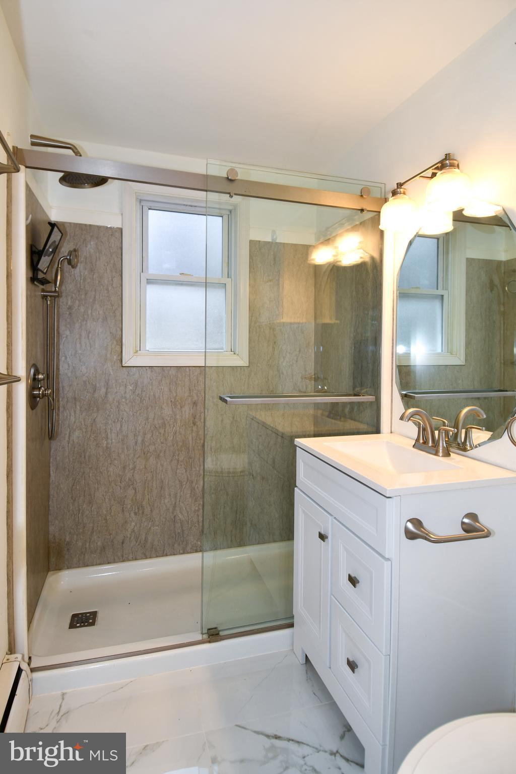 26904 Overlook Street Damascus, MD 20872 - Photo 20 of 54 a bathroom with a sink mirror toilet and bathtub