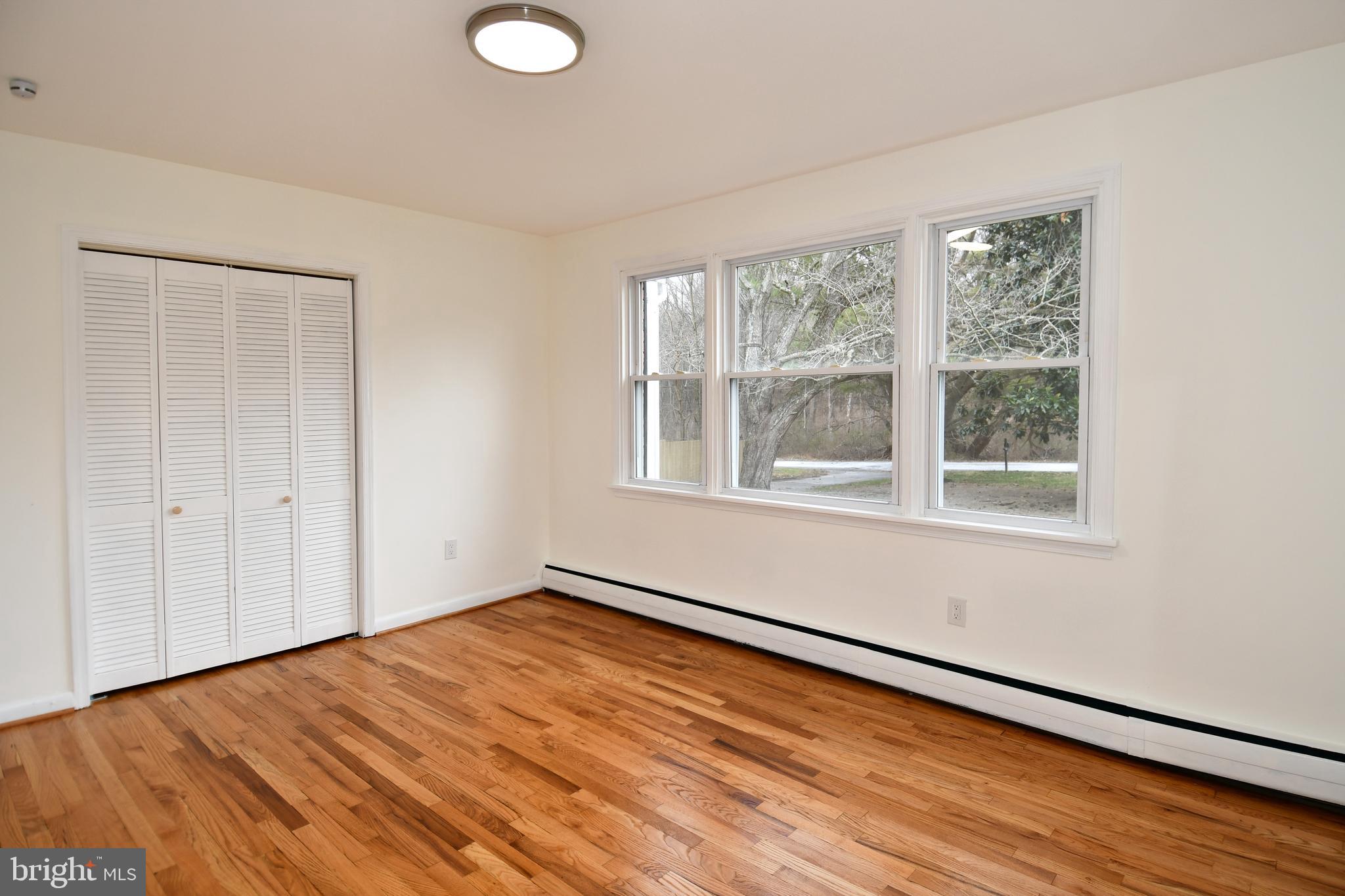 26904 Overlook Street Damascus, MD 20872 - Photo 24 of 54 a view of empty room with wooden floor and fan
