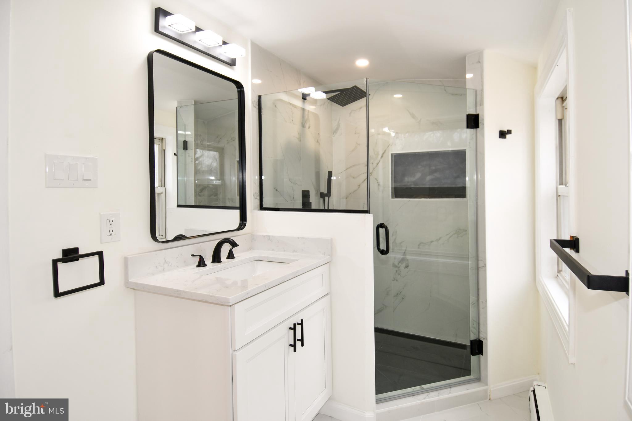 26904 Overlook Street Damascus, MD 20872 - Photo 32 of 54 a bathroom with a sink vanity and mirror