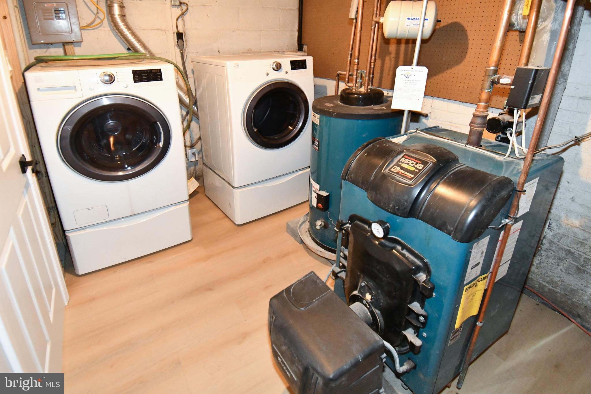 26904 Overlook Street Damascus, MD 20872 - Photo 47 of 54 a utility room with dryer washer and a view of living room