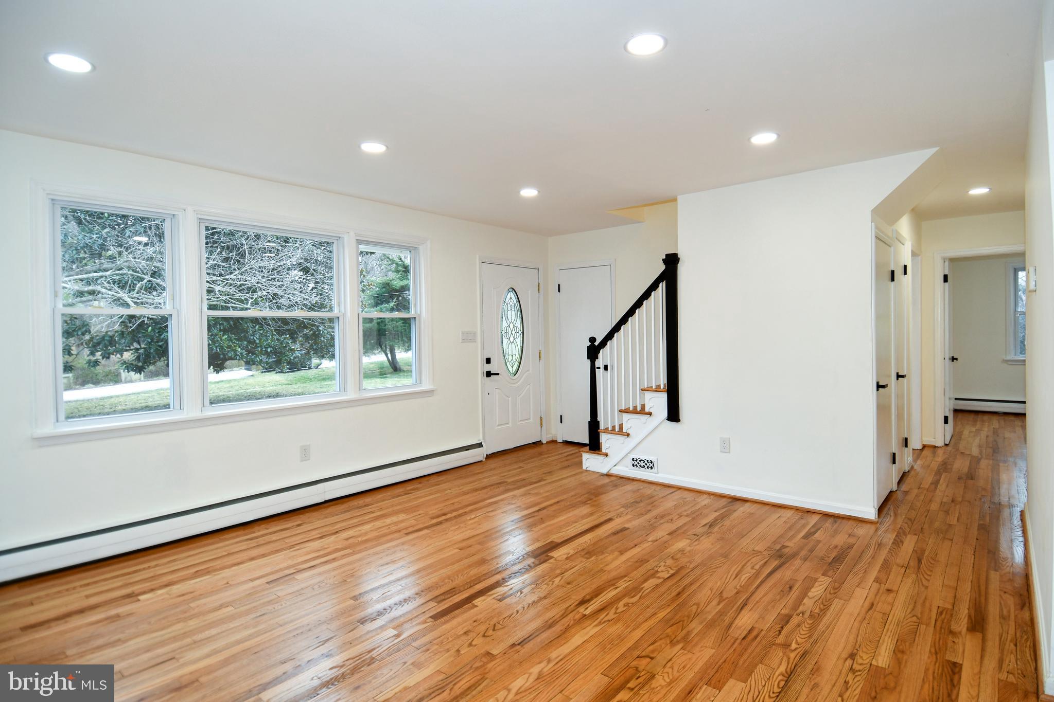 26904 Overlook Street Damascus, MD 20872 - Photo 8 of 54 a view of an empty room with wooden floor and a window