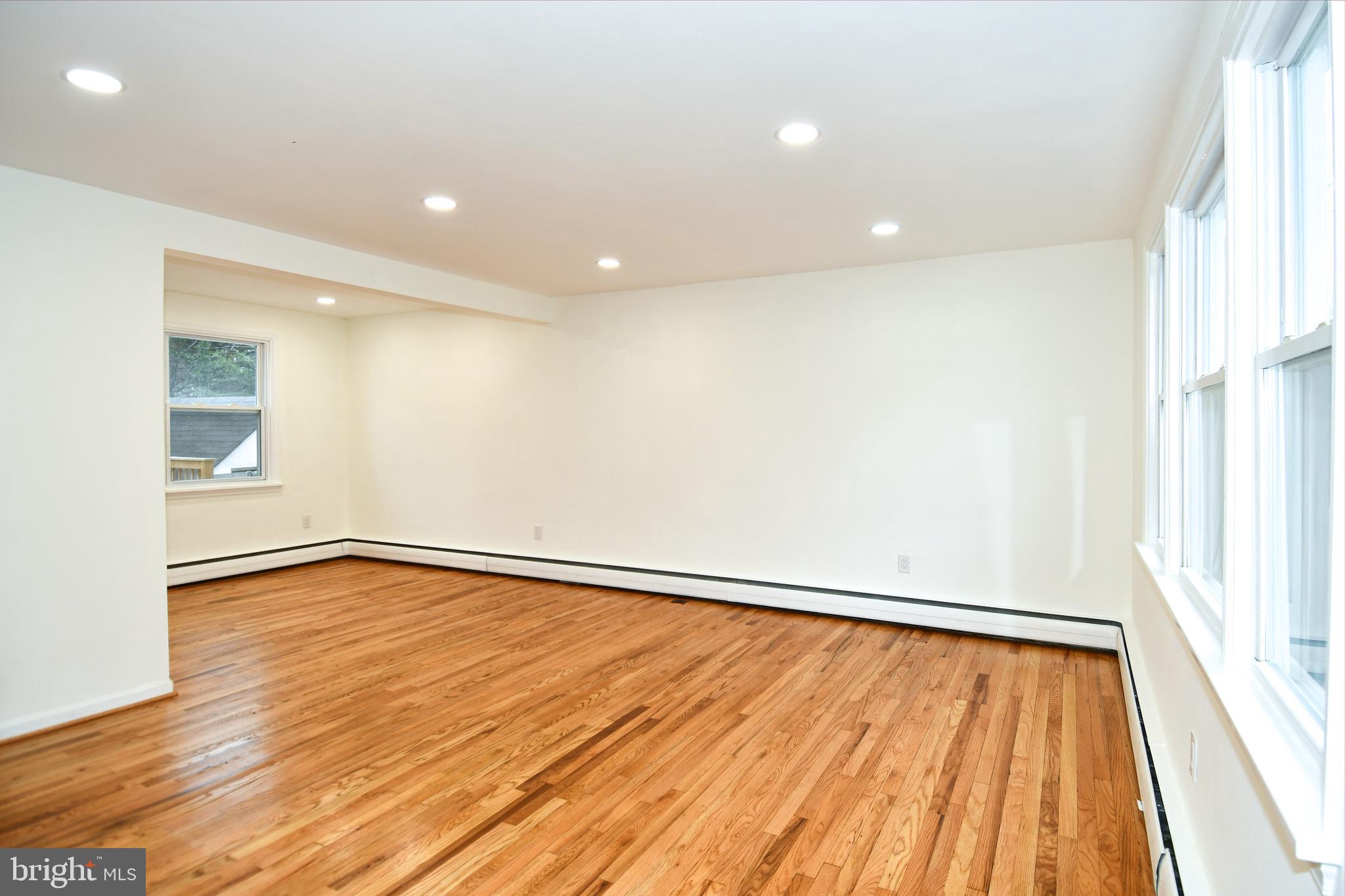 26904 Overlook Street Damascus, MD 20872 - Photo 10 of 54 a view of an empty room with wooden floor and a window