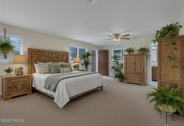 a view of a wooden house with a large tree