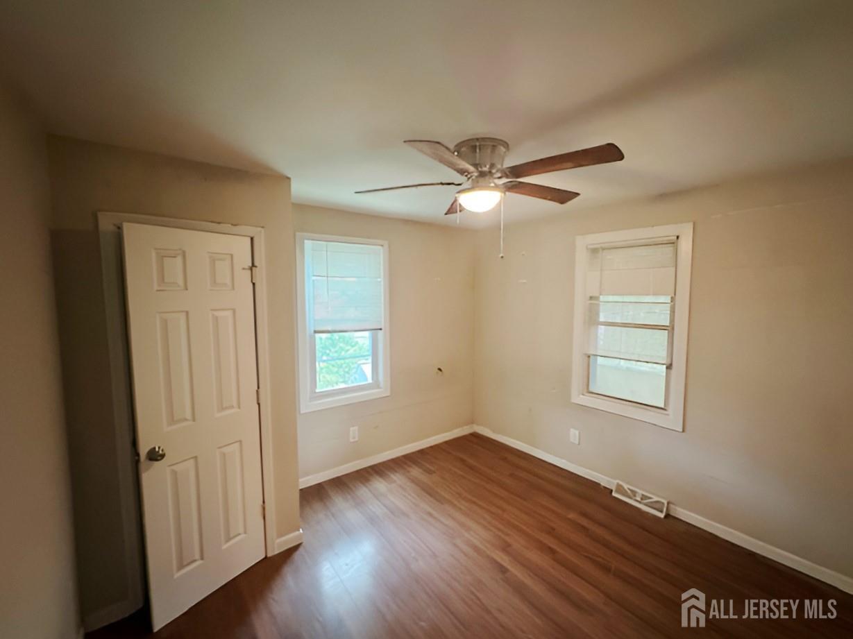 20 Mabel Street Ewing, NJ 08638 - Photo 18 of 31 an empty room with wooden floor windows and fan