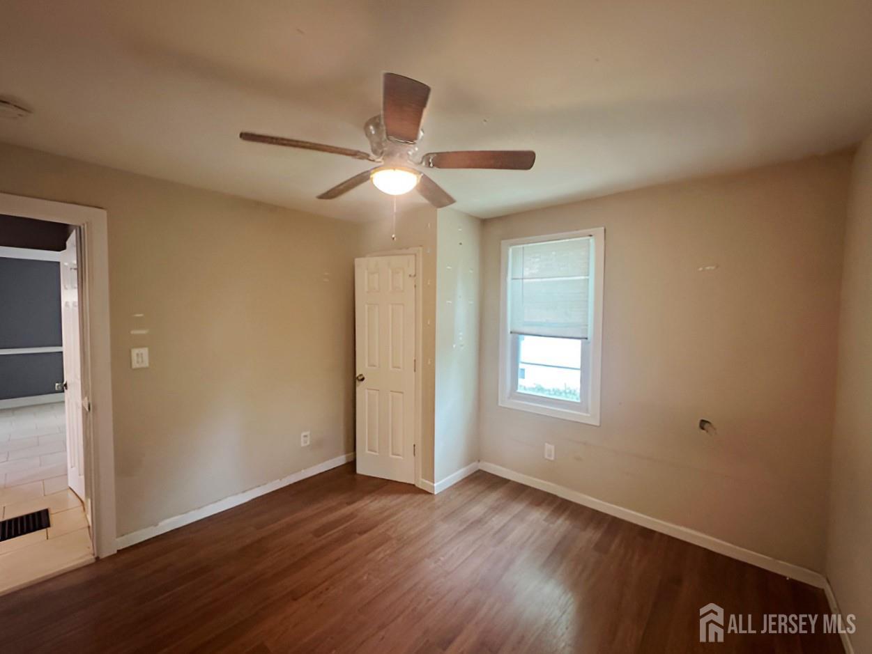 20 Mabel Street Ewing, NJ 08638 - Photo 19 of 31 a view of an empty room with wooden floor and a window