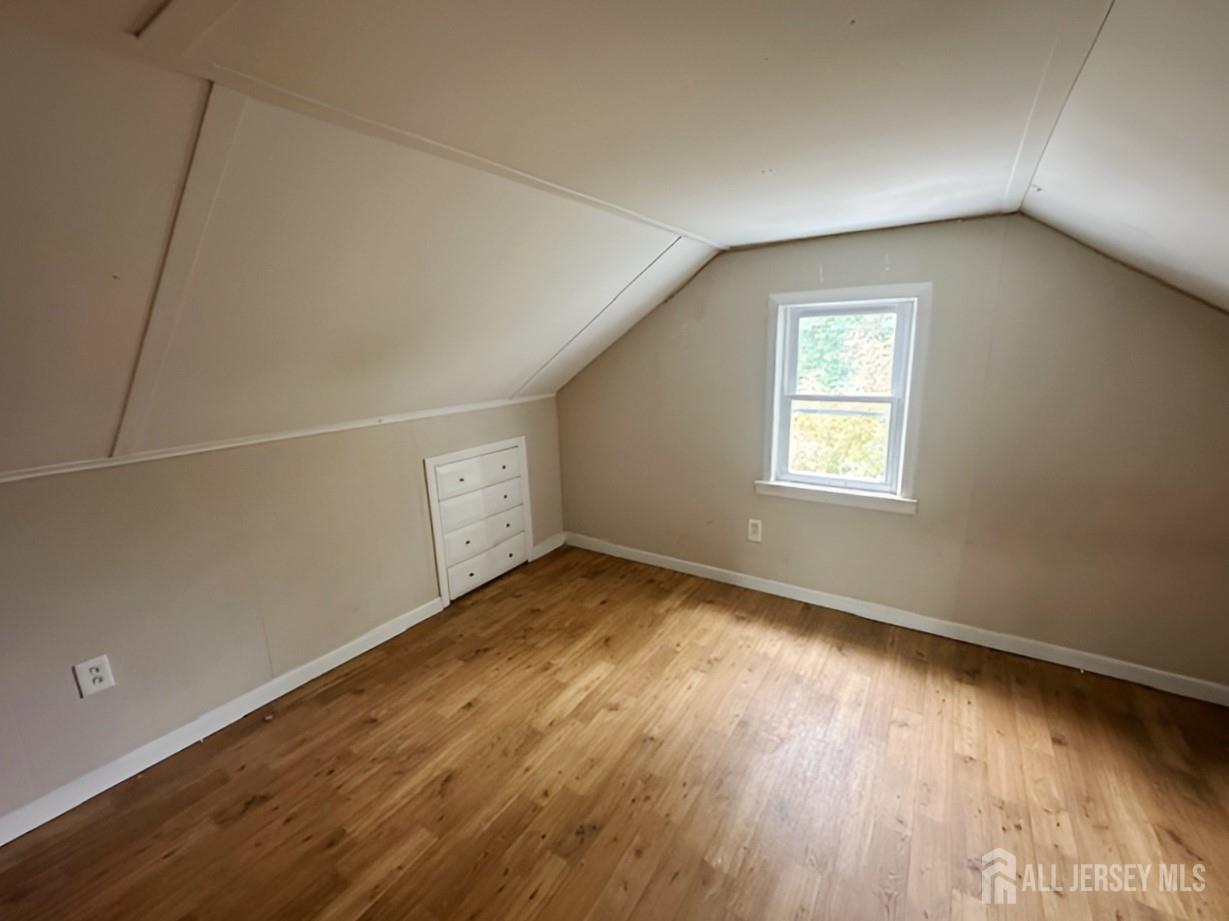 20 Mabel Street Ewing, NJ 08638 - Photo 22 of 31 a view of an empty room with wooden floor and a window