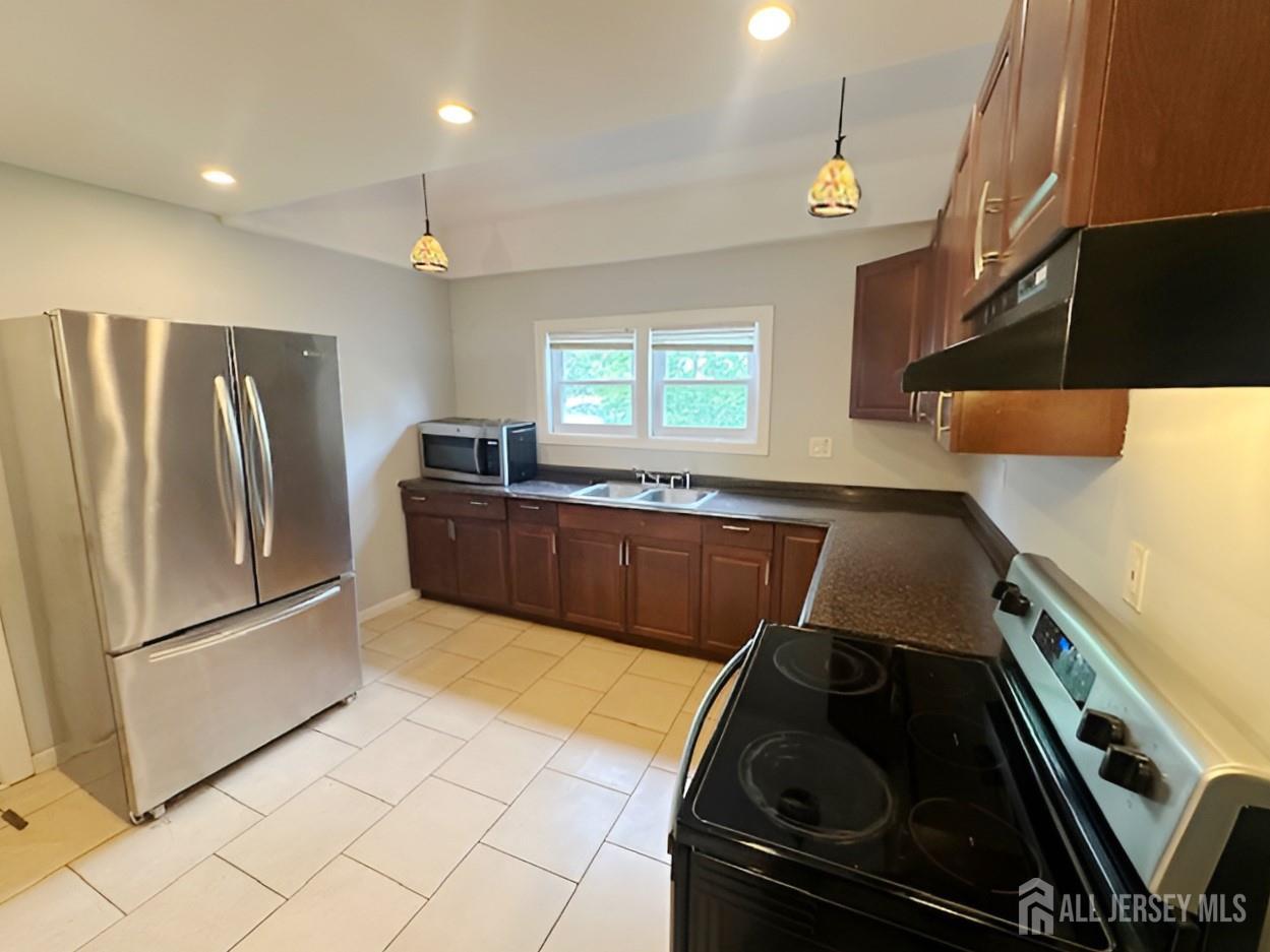 20 Mabel Street Ewing, NJ 08638 - Photo 3 of 31 a kitchen with granite countertop a stove and a refrigerator