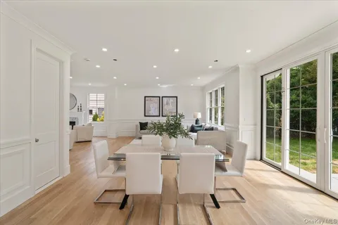 a dining room with furniture and wooden floor