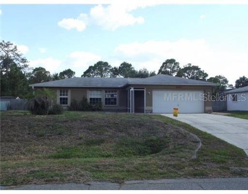 3261 Escobar Lane North Port, FL 34286 - Photo 1 of 1 a front view of a house with a garden