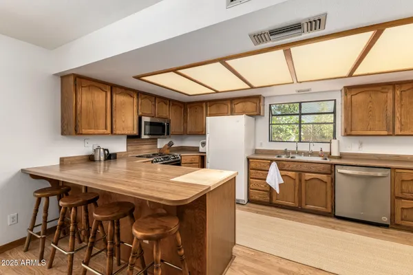 a view of a a dining room with furniture window and wooden floor