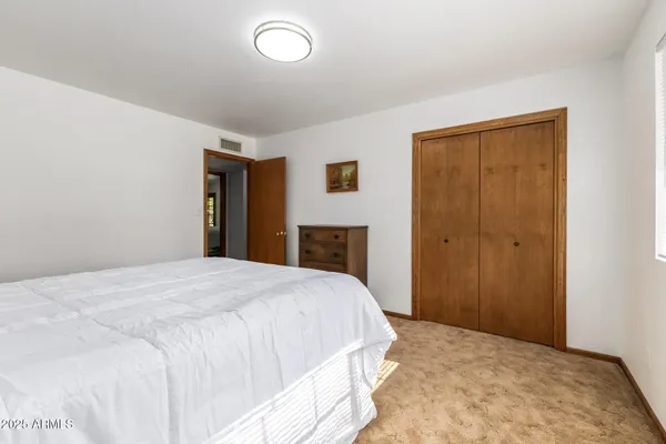 a bed room with a bed and a window