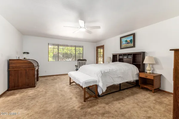 a bedroom with a bed and a mirror