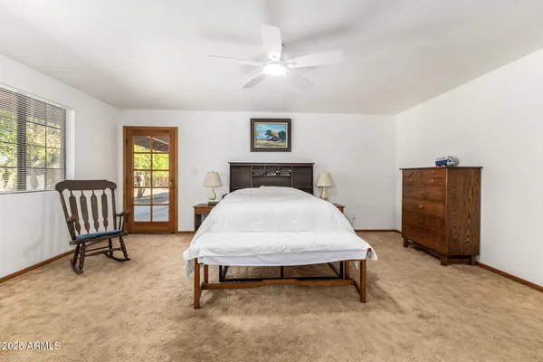 a spacious bedroom with a bed and window