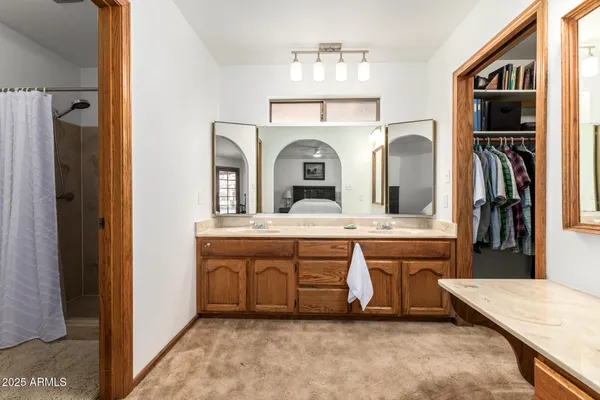 a bathroom with a sink a mirror and a window