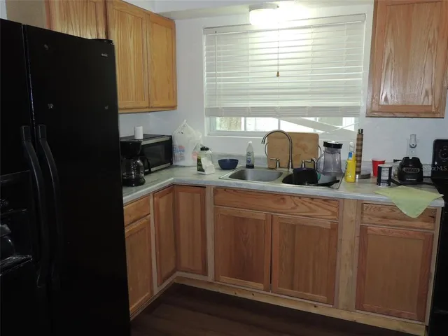 a kitchen with stainless steel appliances granite countertop a refrigerator and a sink