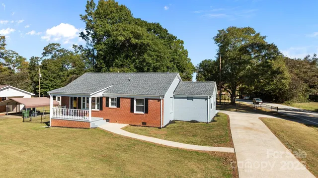 an aerial view of a house with swimming pool and ocean view