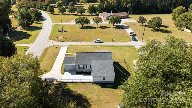 an aerial view of a house with a yard