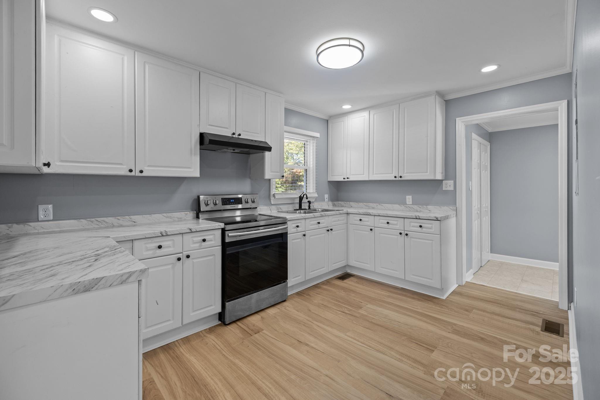 1804 Bennett Road Lancaster, SC 29720 - Photo 7 of 41 a kitchen with granite countertop white cabinets and stainless steel appliances