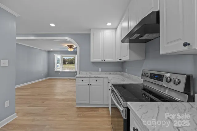 a kitchen with a sink stove and cabinets