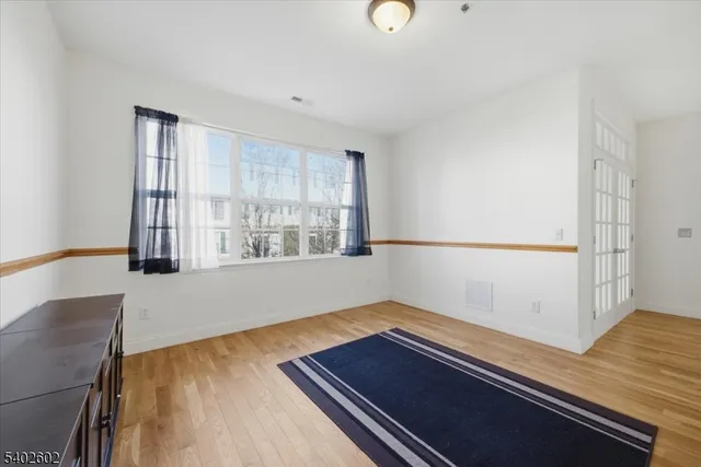 a room with wooden floor and window