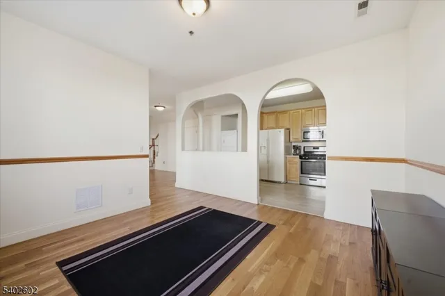 a kitchen with a refrigerator a sink and cabinets