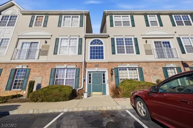an aerial view of residential building with parking