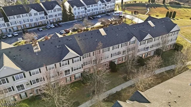 an aerial view of residential building with parking